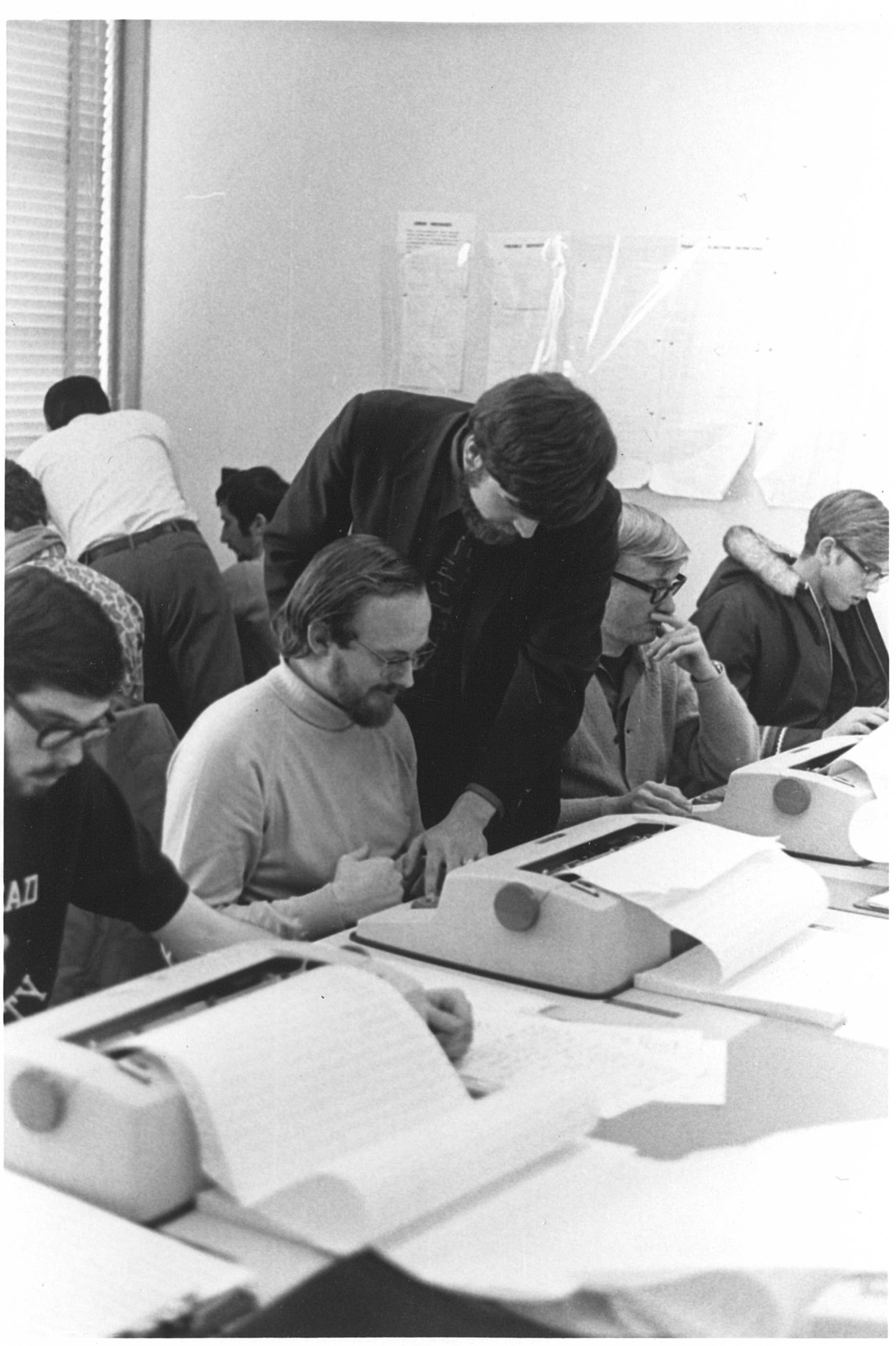 Computer Centre employees help users at Lakehead APL terminals in the 1970s.