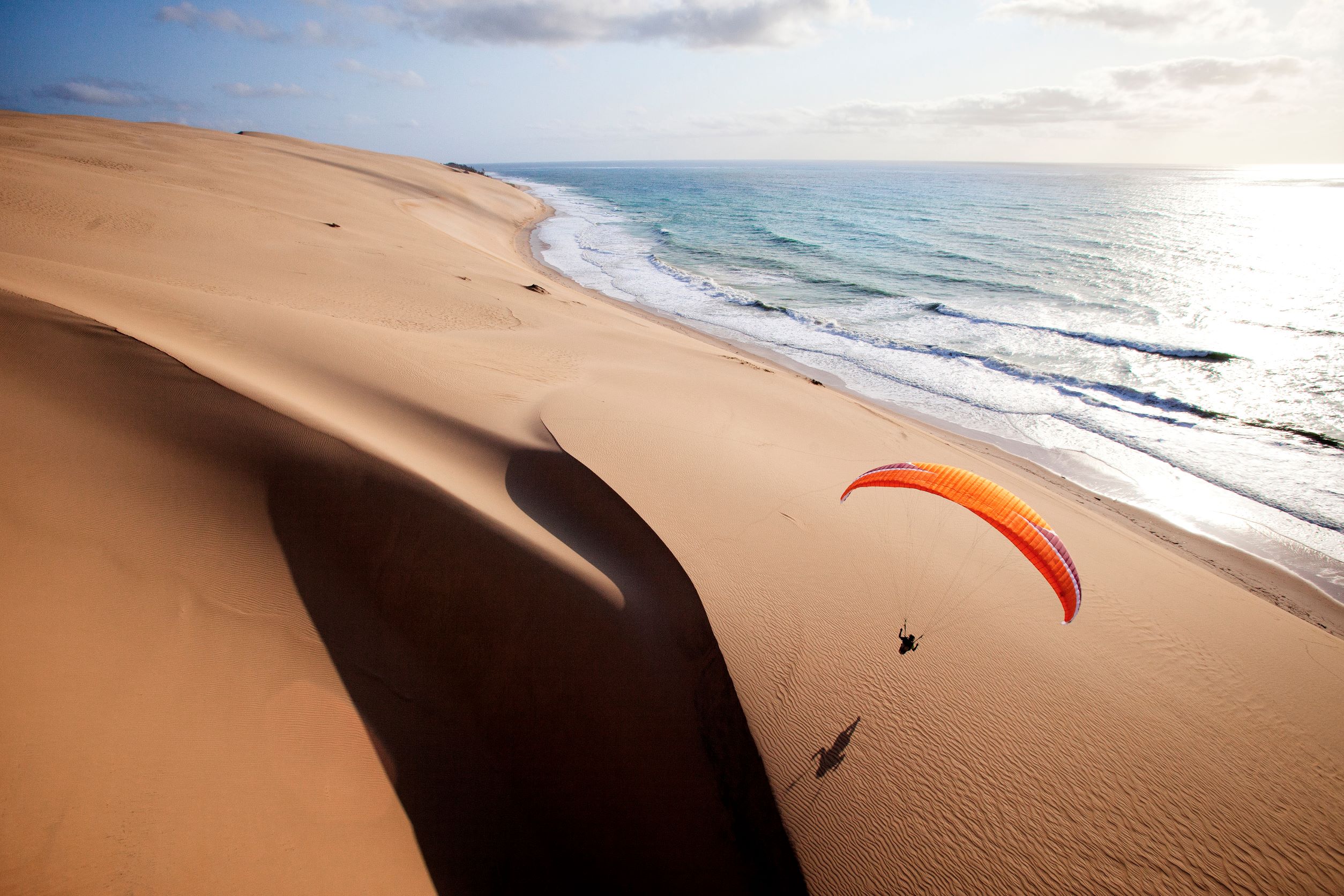 Paragliding over a sand dune in Mozambique