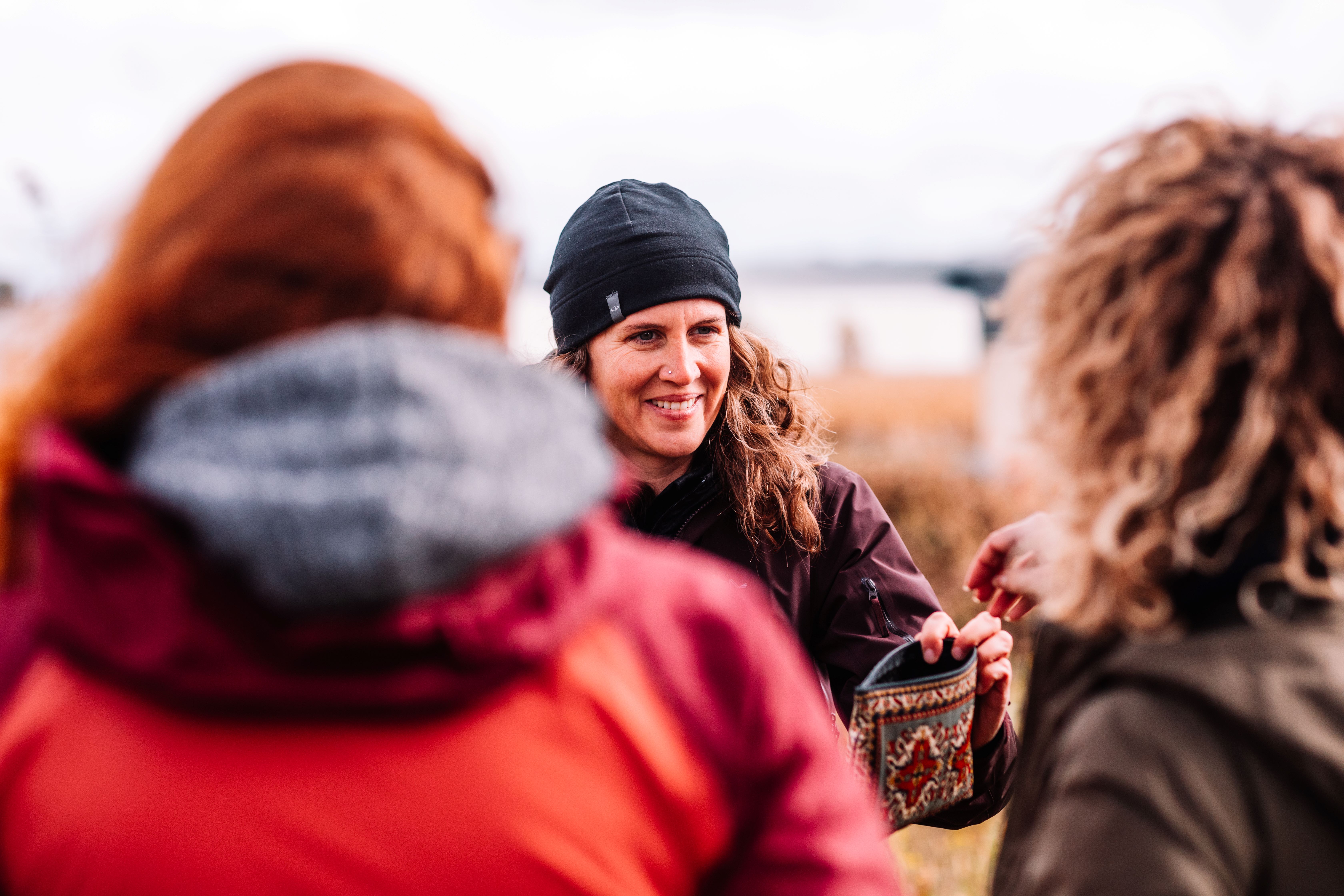 Dr. Ellen Field outside with two students in the autumn