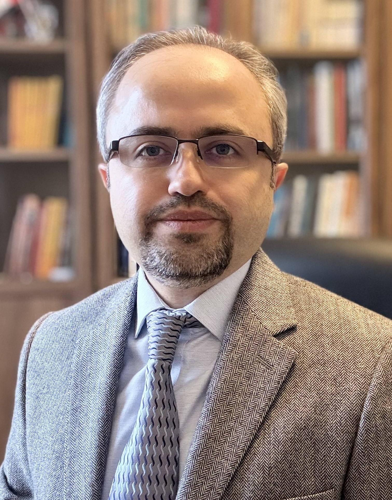 Dr. Davut Akca wearing a jacket and tie
