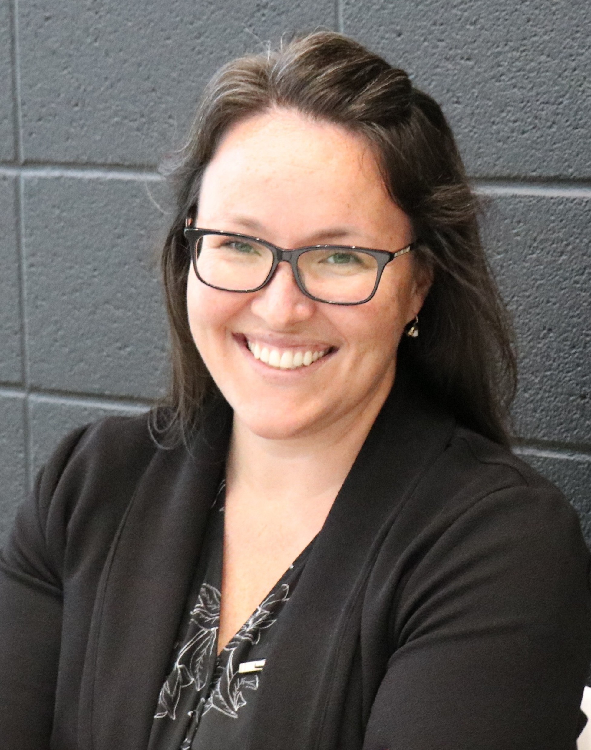 Dr. Taryn Klarner wearing a black blouse and black sweater