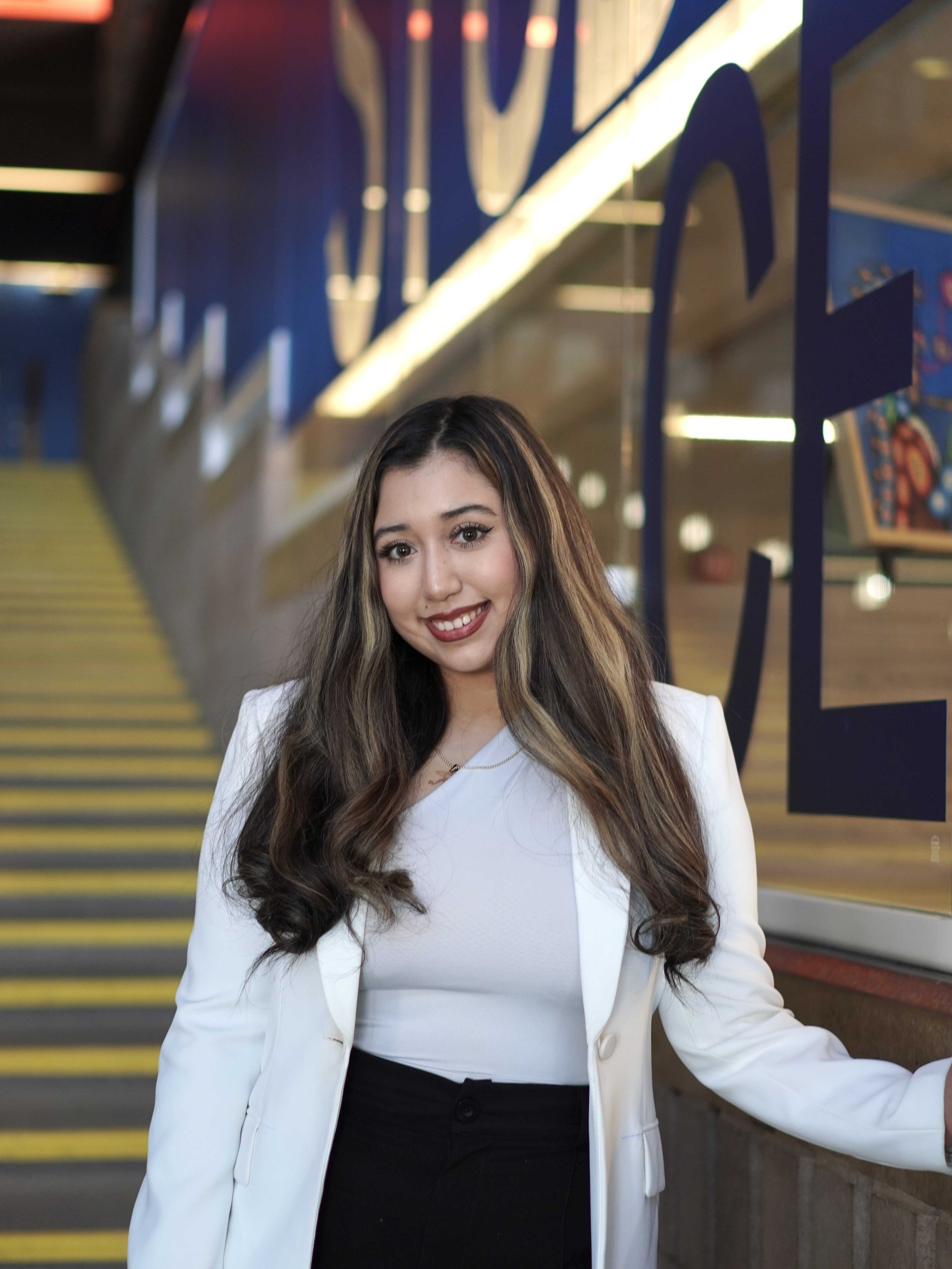 Aliss Chavarri in Agora Aliss Chavarri stands at the bottom of the staircase in the Agora next to Student Central