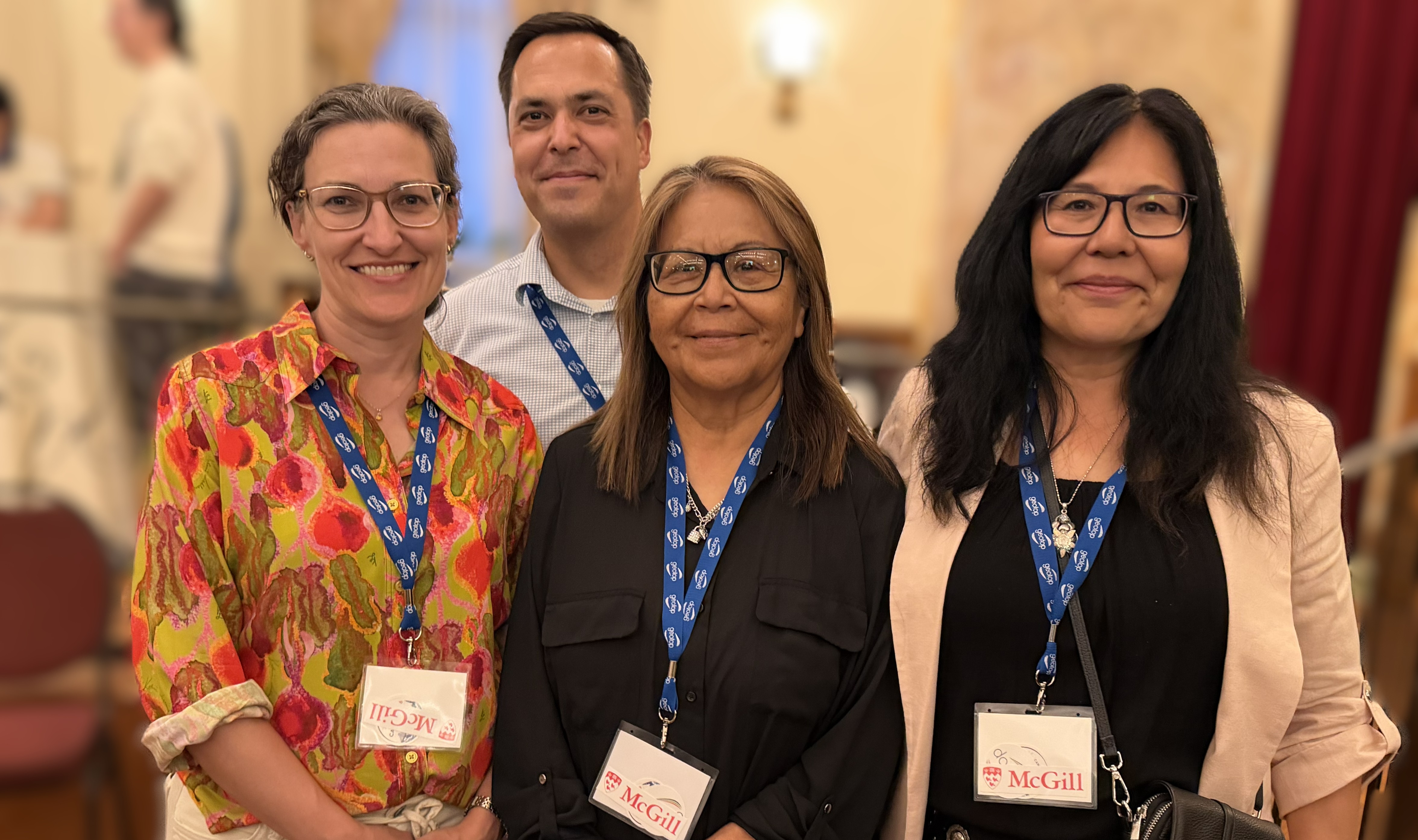 2026 Canadian Quaternary Association Conference A group of four people wearing lanyards and business casual clothing