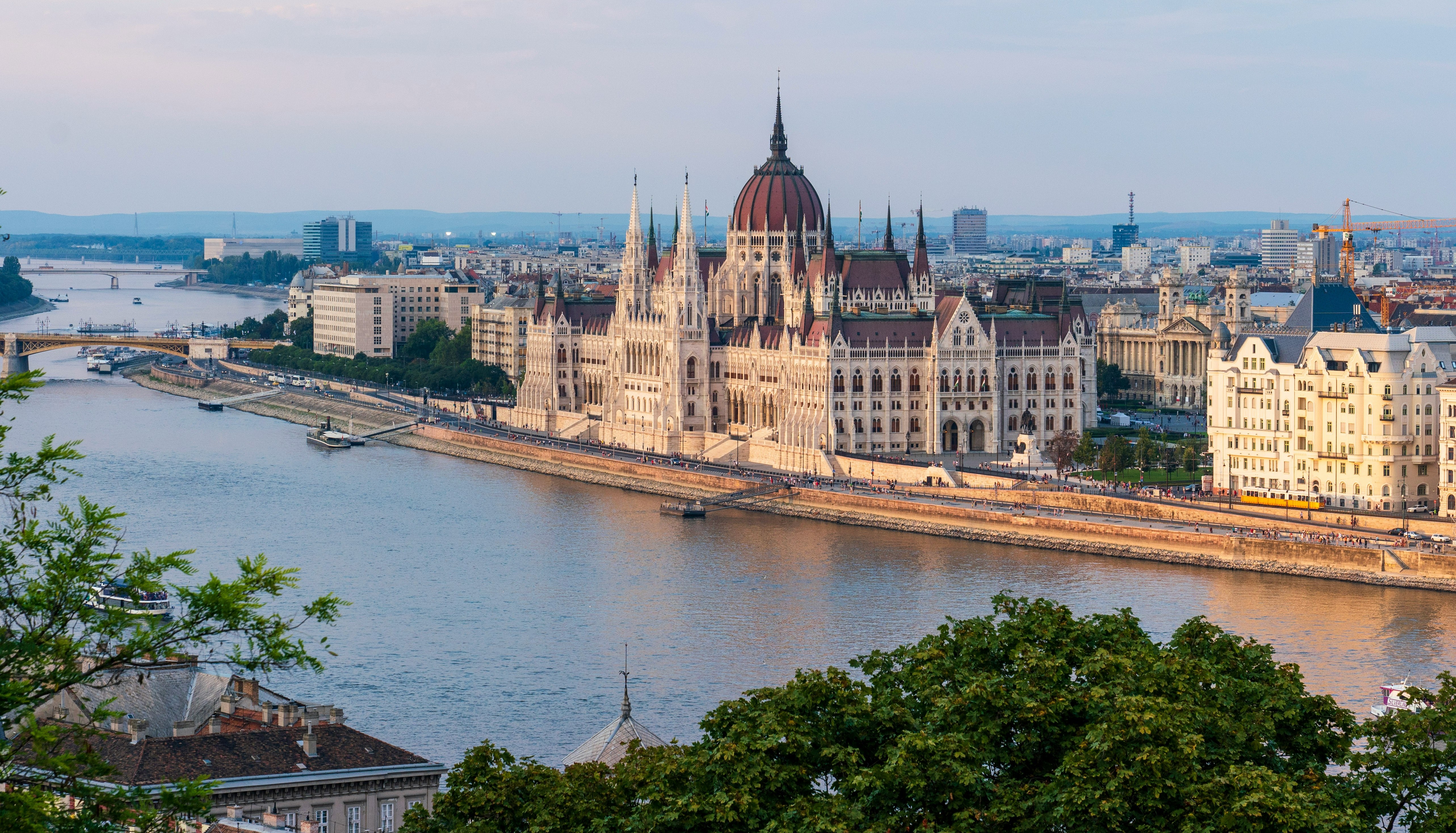 A view of the Danube River, Hungary's large ornate parliament building, and commerical and residential buildings