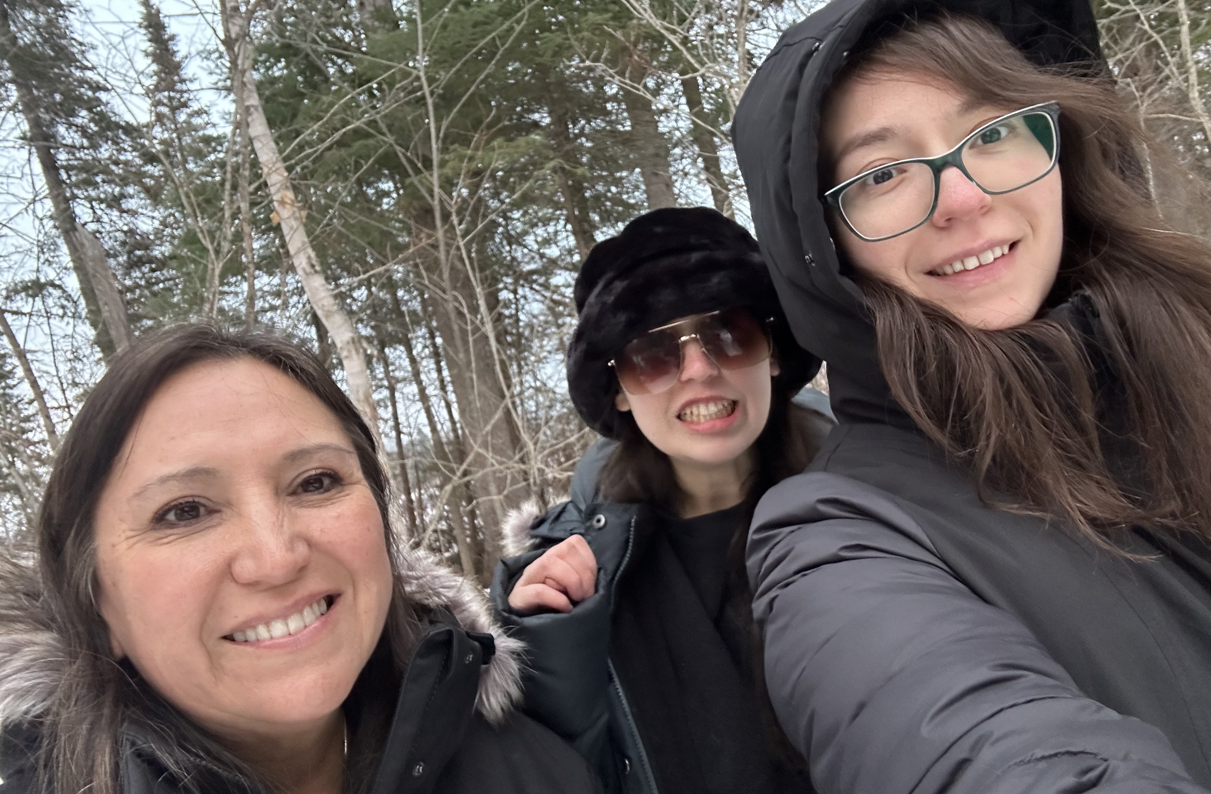 Hannah O'Donnell with her Family Hannah O'Donnell's mother, sister, and Hannah stand outside in a forested area