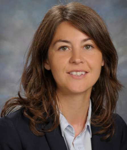 A head-and-shoulders image of Larissa Speak wearing a collared shirt and a dark blazer