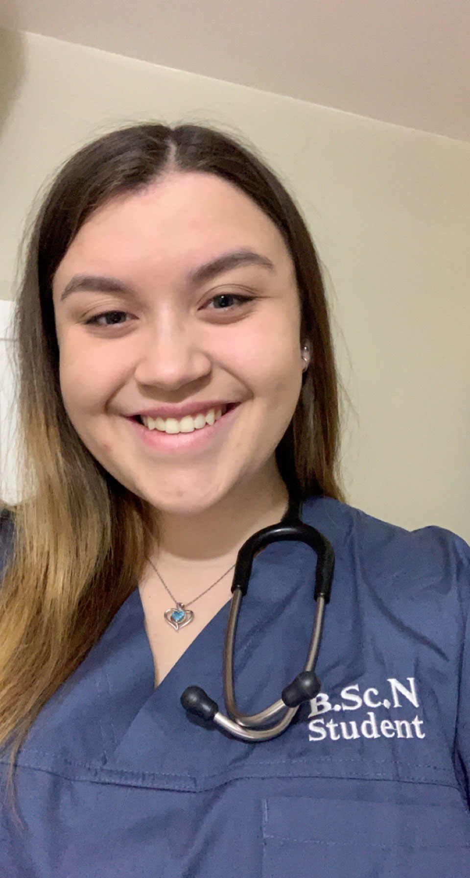 Nursing student Emily Kaun wearing hospital scrubs
