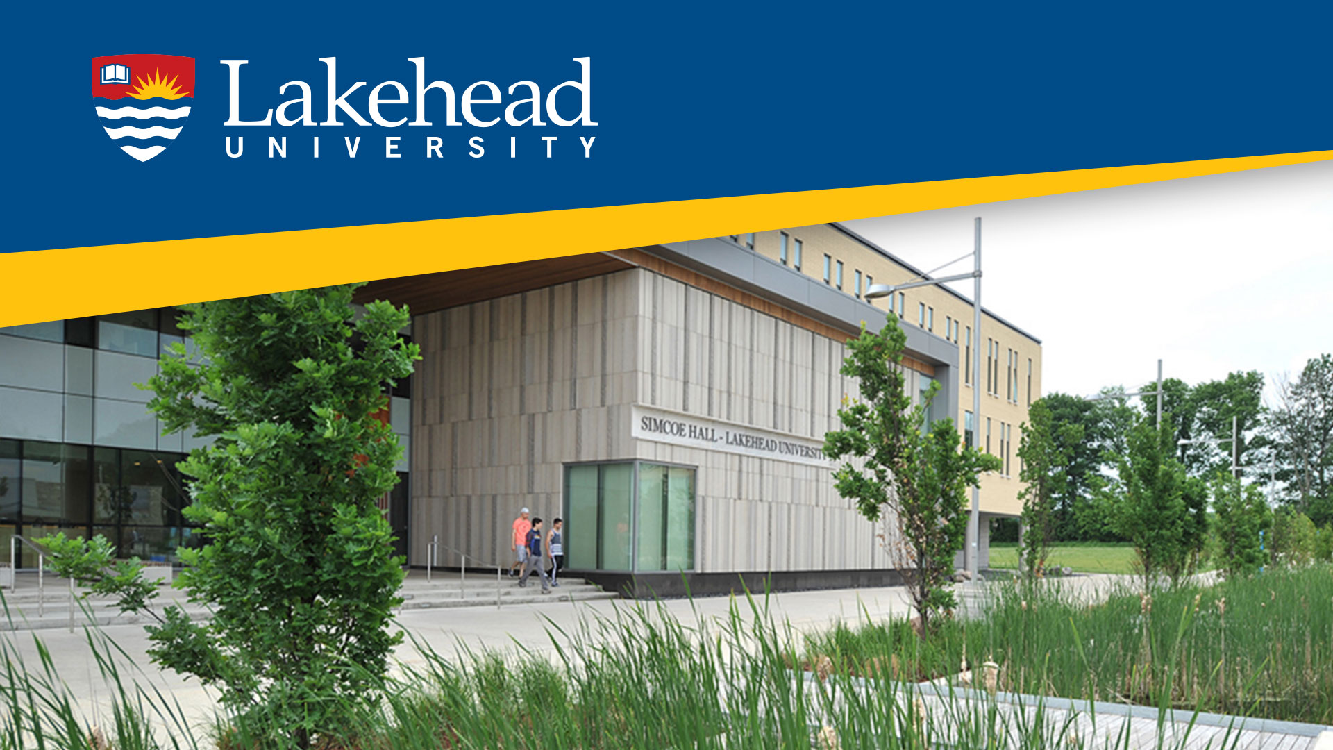 Campus shot of Lakehead Orillia on a clear day with the Lakehead Logo at the top