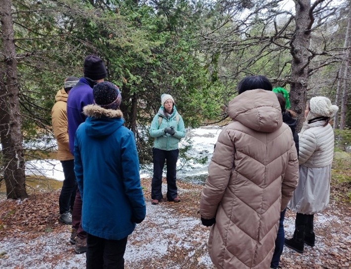 Acting Sustainability Coordinator Rachel Portinga discusses one of archeological sites along the McIntyre River.  