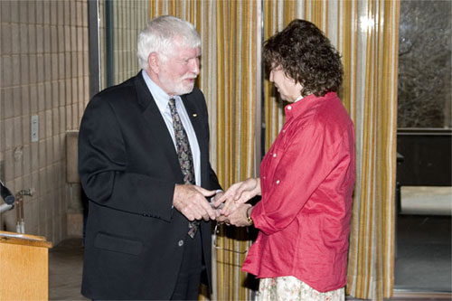Margaret McLean receiving 20 year pin from Dr. Fred Gilbert
