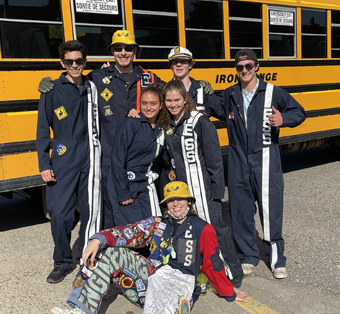 Photo of our students in front of a bus on the way to a club event