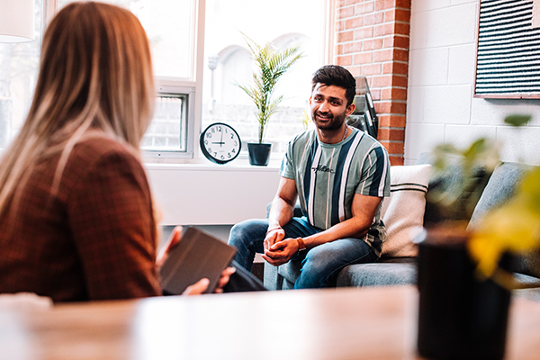 A patient sitting and speaking during a session