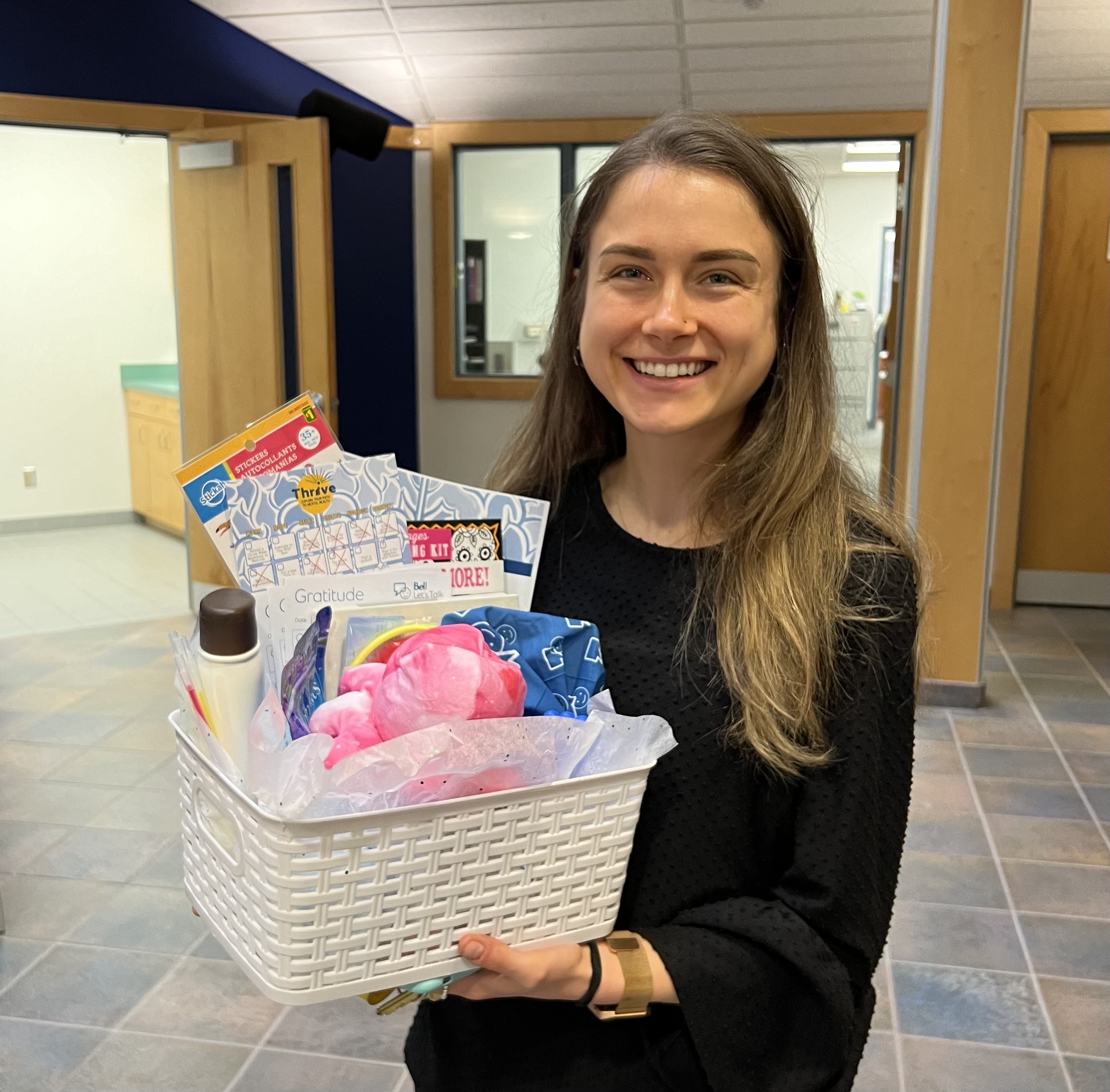 Vanessa Nichols winner of a self-care basket smiling for the photo