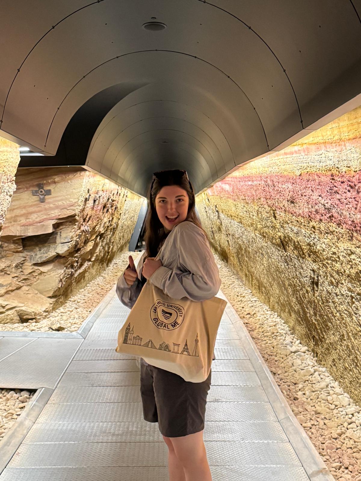 Student in tunnel with Global ME tote bag