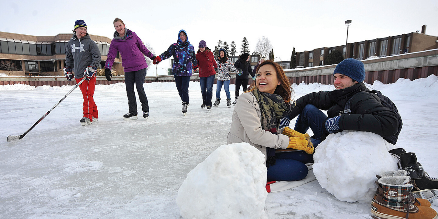 A group of student skating on Lake Tamblyn on Lakehead Thunder Bay's campus