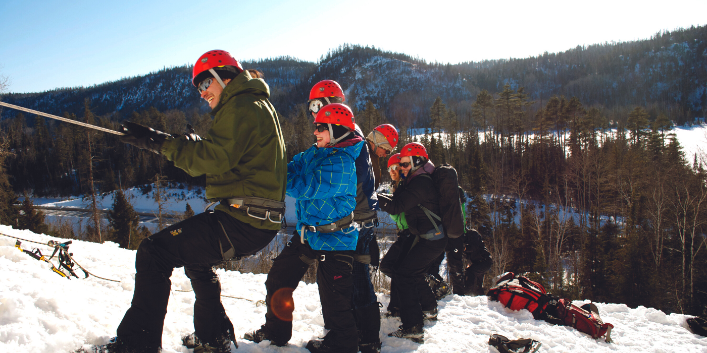 A group of student ice climbing on a mountain.