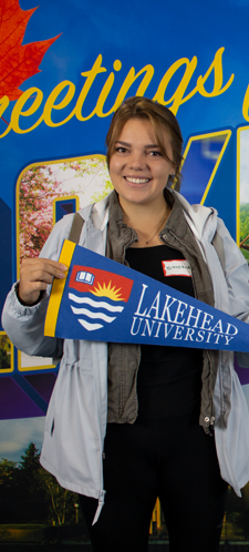 Student holding Lakehead University flag