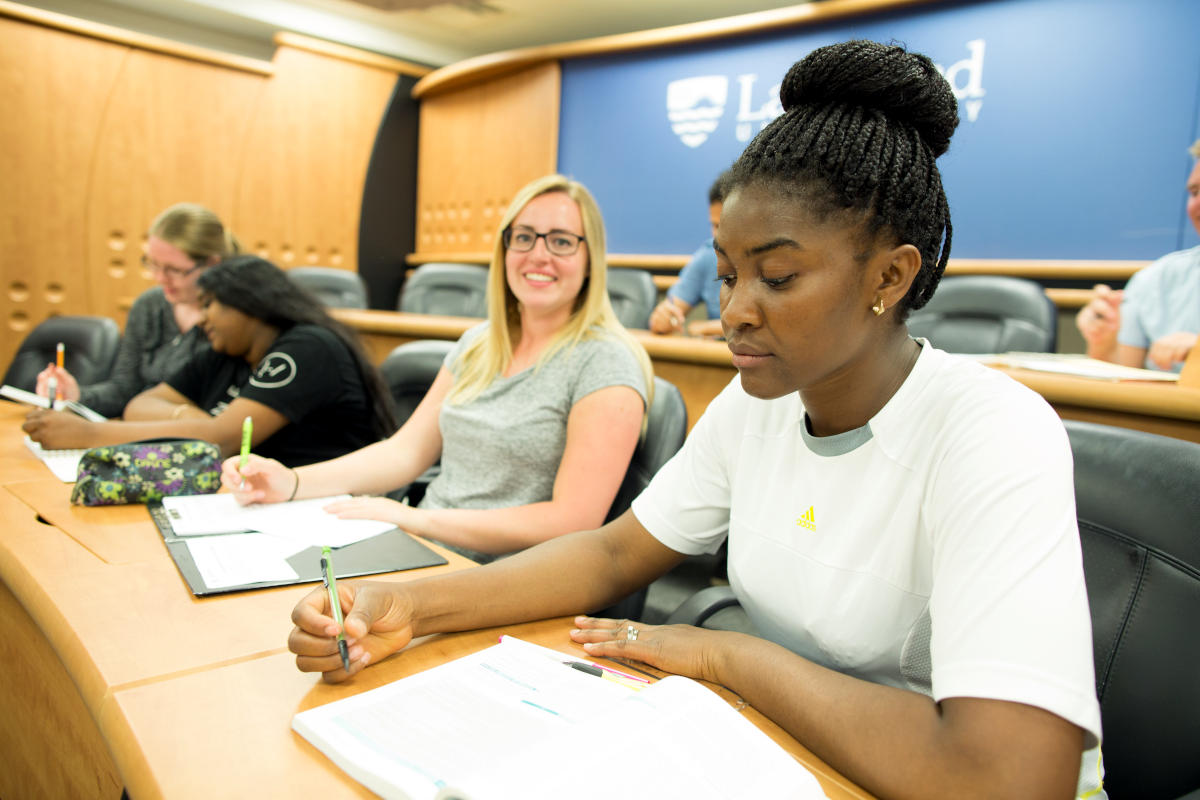 Students writing and smiling