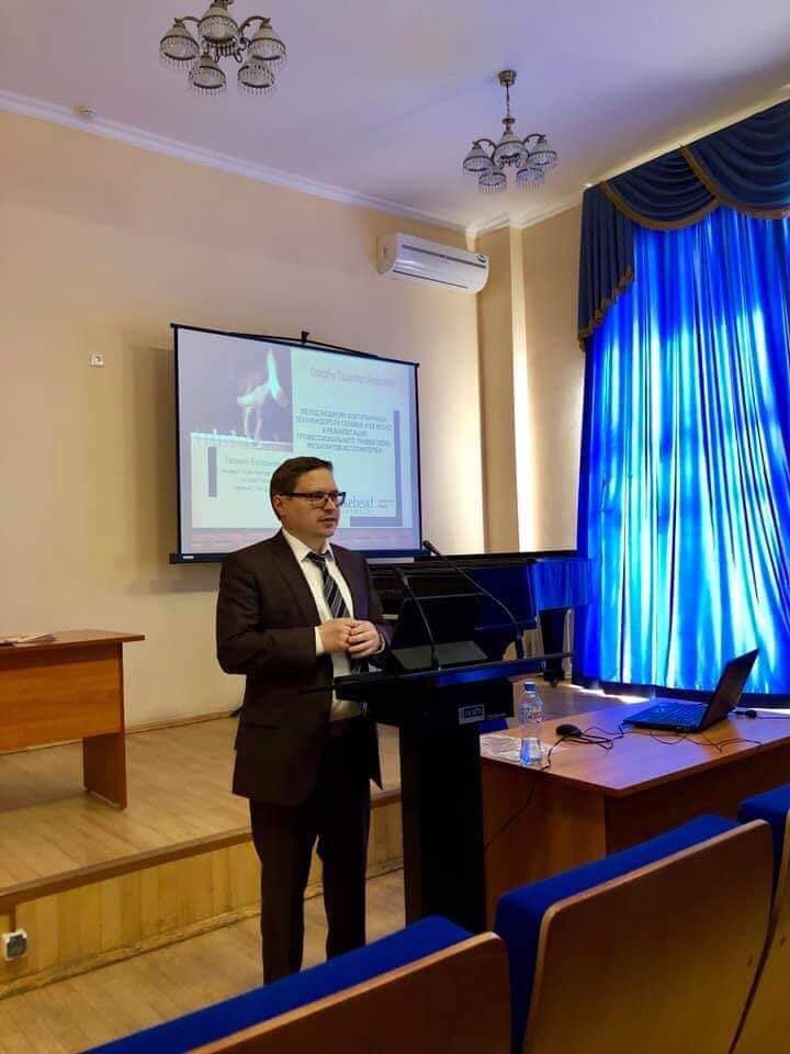 Dr. Evgeny Chugunov at a podium