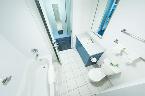 The dorm room bathroom including an additional sink, toilet and tub/shower